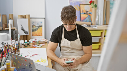 Captivating portrait, serious young hispanic man, an attractive artist, engrossed in learning art...