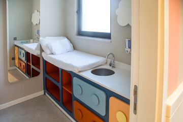Cozy children's room for washing and changing babies, changing diapers.