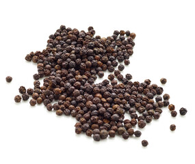 Pile of black pepper peppercorn seeds isolated on white background