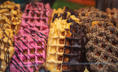 Colorful waffles glazed with chocolate. Buy traditional Dutch dessert food in Amsterdam