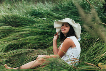 Girl smiling in the grass in summer