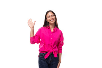Obraz na płótnie Canvas young confident strong brunette woman leader wears a bright pink shirt on a white background