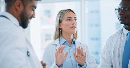 Fototapeta premium Group conversation, doctors meeting or woman planning, brainstorming or collaboration in medical clinic. Communication, leader or team surgeon, nurses or expert consulting on problem solving solution