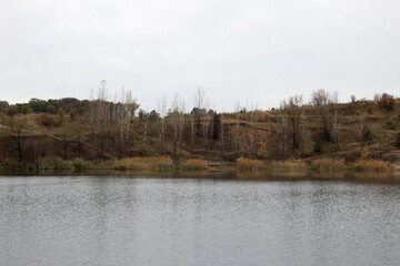 Panorama of the lake in autumn. Claudy day in nature.