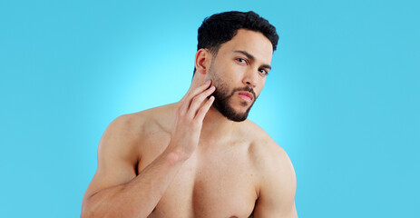 Fototapeta premium Man, portrait and beard in grooming, skincare or hygiene isolated against a blue studio background. Face of handsome or attractive male person or model in beauty, facial cleaning or routine on mockup