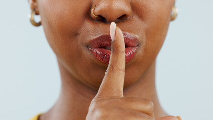 Black woman, mouth and lips in secret for gossip, privacy or confidential information against a...