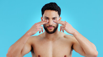 Skincare, portrait and man with eye patches for anti ageing treatment isolated on blue background....