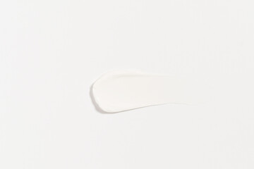 texture of a white smear of cream on an isolated background. concept of beauty products for moisturizing and skin care