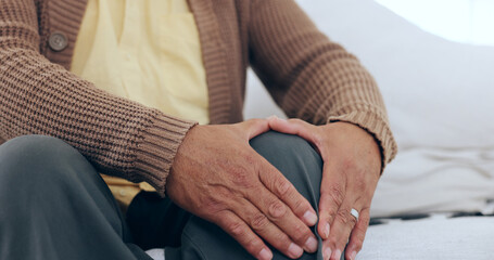 Hands, knee pain and senior man on a sofa with arthritis, fibromyalgia or osteoporosis closeup....