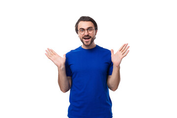 young smart confident caucasian brunette man with a beard in a blue t-shirt on a white background