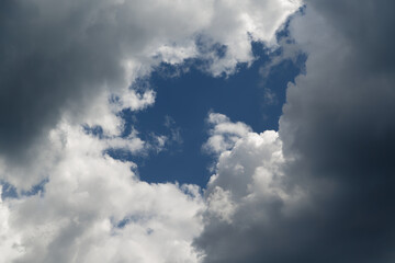 A gap in the clouds through which the blue sky is visible