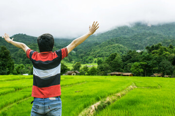 Asian man at green terraced rice field, Mae Klang Luang Chiangmai