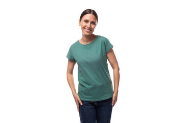 young slender european woman with a ponytail hairstyle is dressed in a green t-shirt smiling cutely