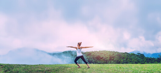 Asian women relax in the holiday. Play if yoga, natural caves, forests, mountains and mist.