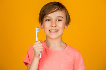 Dental hygiene. Happy little kid brushing her teeth. Kid boy brushing teeth. Boy toothbrush white toothpaste. Health care, dental hygiene. Joyful child shows toothbrushes. Little boy cleaning teeth