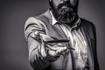 Bearded man, bearded male. Portrait of stylish man beard. Barber scissors and straight razor, barber shop. Vintage barbershop, shaving. Black and white