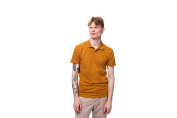 young stylish guy with red hair is dressed in a mustard-colored T-shirt
