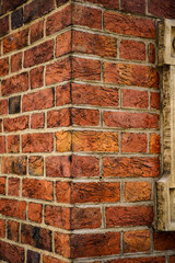 Old building corner made of red bricks 