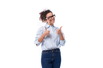 smart stylish young brunette curly employee of the company woman dressed in a light blue shirt on the background with copy space