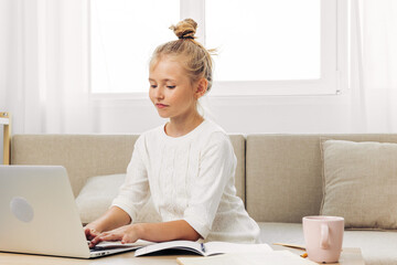 Laptop distance online child couch homework learning schoolgirl education school