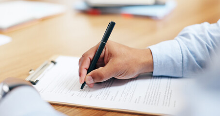 Closeup, hand and signature for clipboard in office for writing on legal form, compliance or application. Person, lawyer or document by information, reading or agreement by contract paperwork on desk