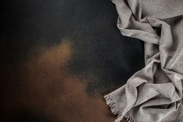 a towel on the kitchen table, cook background, on a dark background. top view. copy space for text