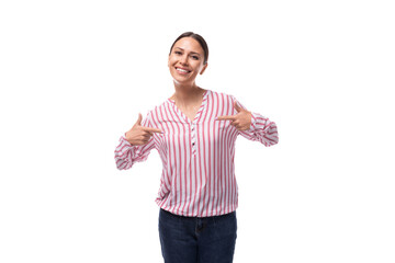 young brunette secretary woman with a ponytail hairstyle dressed in a striped blouse smiling on a white background