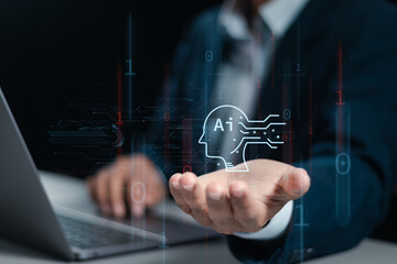 AI technology, Businessman use laptop and holding global AI tools for big data network connection by use artificial intelligence technology to help solve work problems.