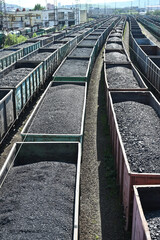 Trains of railway wagons full of coal