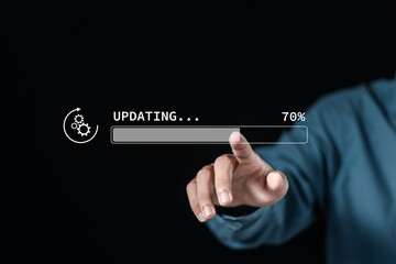 Hand touching downloading progress bar and installing update process. Software updates or operating...