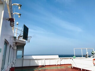 Deck of a white ship on blue sky background