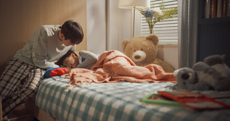 Father Enters Children's Room to Wake Up His Two Adorable Little Kids. Girl is Playing with Toys, Boy Sweetly Wakes up. Beautiful Korean Family Ready to Spend Sunny Day Together Playing and Having Fun © Kitreel