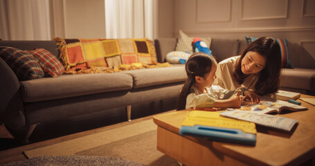 Mother and Cute Little Daughter Drawing together in the Living Room. Carin Mom with Her Sweet Daughter Learning to Draw Creatively, Spending Time Together. Happy Korean Family