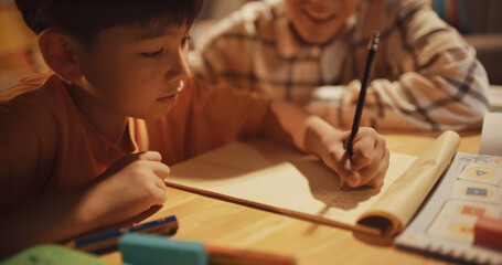 Portrait of Smart Young Boy Doing Homework with Helpful Father Teaching Him Math, Science,...