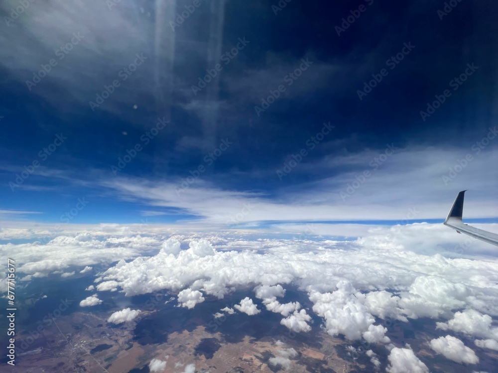 Canvas Prints Aerial view of a rural landscape enveloped in puffy clouds in blue sky background