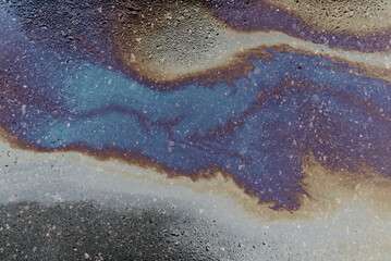 Fototapeta na wymiar Abstract background from motor oil, gas or petrol spilled on asphalt