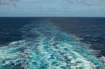 Wake of a cruise ship on the open ocean. Water trail in the sea tlt ocean behind a cruise liner....