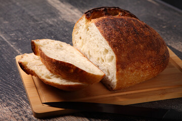 fresh round bread sliced on a board