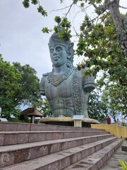 Fototapeta na wymiar Vertical shot of a giant statue of Vishnu in the Garuda Wisnu Kencana Cultural Park in Bali.