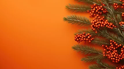 Fotobehang  a branch of a christmas tree with red berries and green leaves on an orange background with a place for a text or an image with a place for your own text.  generative ai © Nadia
