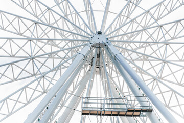 Big tall white ferris wheel in front of perfect blue sky in Bukovel. Carpathians Ukraine