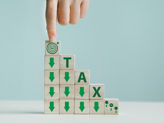 Wooden block with tax deduction icon to achieve environmental goals Using environmental taxes,...