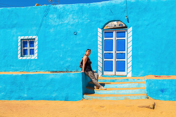Woman tourist walks through the famous Nubian village.