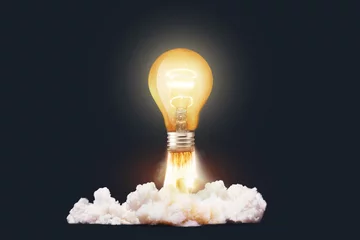 Foto op Plexiglas Creative light bulb rocket with blast and clouds takes off on a dark background, concept. Successful launch start up, creative idea. Think differently. Creative generator. Smart and thinking © alones