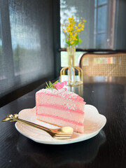 Three layer sponge cake which is decorated with sweet pink tones sweet scent and decorations using fresh flowers Attracting you to choose to eat. 