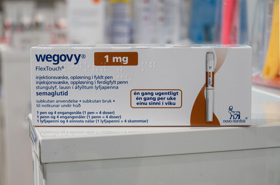 Packaging box of Wegovy (semaglutide) injectable prescription medication, weight-loss drug from Novo Nordisk AS. Pharmacy shop shelves in background. Copenhagen, Denmark - November 13, 2023.