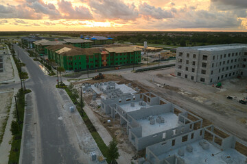 Top view of apartment buildings under construction in new developing suburban area. Development of...