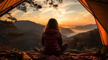 Wandaufkleber Lonely woman with tent, relaxing in quiet mountain landscape at sunset © senadesign
