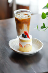 strawberry shortcake or strawberry cake with strawberry and blueberry topping and iced coffee