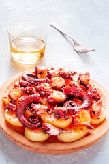 Pulpo a la gallega, Spanish octopus snack, Galician dish, with wine at a restaurant